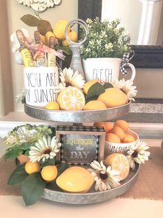 a three tiered tray filled with oranges and lemons