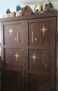 a wooden cabinet with gold stars painted on it