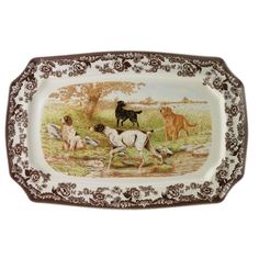 an antique porcelain tray with horses and dogs on the front, brown trimmings