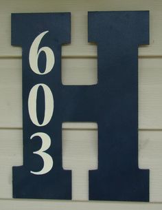 a house number sign on the side of a building