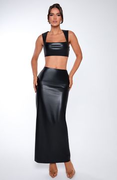 Amp up the drama in Odetta, a sleek, sexy maxi cut from soft faux leather with a mid rise fit, pencil shaped skirt and split to the centre back. Style her up with the Amaya crop or a bodysuit. 



Colour: Black.

Premium faux leather with slight stretch.

Fully lined.

Mid rise.

Pencil shaped skirt.

Split to centre back.

Invisible zip fastening.

Maxi length.

Model is an XS and is wearing an XS.

 Size: XS, S, M, L, XL, XXL Black Fitted Skirt With Fake Two-piece Detail, Black Leather Split Skirt, Fitted Faux Leather Chic Crop Top, Sleek Luxury Black Maxi Skirt, Luxury Black Faux Leather Skirt, Split Long Dress, Loungewear Dresses, Maxi Dress Sale, Maxi Dress Navy