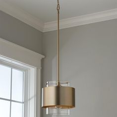 a light fixture hanging from the ceiling in a room with white walls and gray carpet