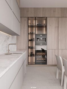 a kitchen with marble counter tops and white chairs in front of an open cabinet door