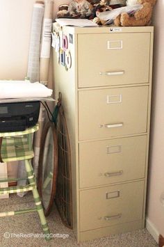 a filing cabinet with several drawers and stuffed animals sitting on top of it next to a baby's crib