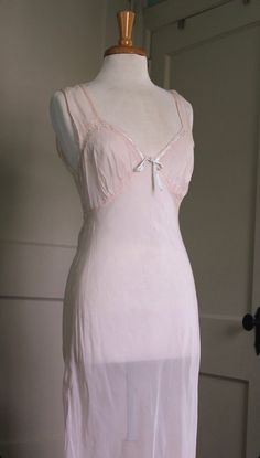 "1940's sheer bias cut slip dress Beautiful sheer ballet pink rayon/nylon (no material tag). Contrasting baby blue bow along the top of the bustline. Ties in the back. Dreamy! In good shape - some small holes throughout, including one in the front. Can be mended with a few stitches. Factored into price. Best fits xs-m depending on your desired fit. Bias cut dresses are meant to melt right onto the body and can fit a variety of sizes.  Bust: 32\" - 36\" Waist: 30\"-34\" Hips: 46\" taut Length: 57 Princess Letters, Bias Dress, Cut Dresses, Vintage Slip Dress, Transparent Dress, Bias Cut Dress, Vintage Slips, 1930s Fashion, Ballet Pink