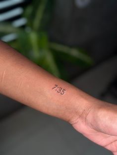 a person with a small tattoo on their arm