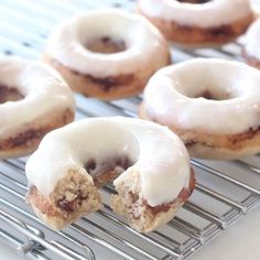 glazed donuts with white icing on a cooling rack