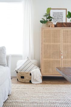 a living room with white walls and wicker furniture