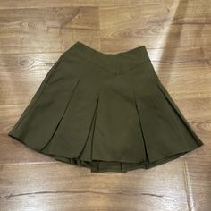 Mini Skirt Have Shorts Inside Olive Green Color One Pocket At Side Thick Material Green Lined Skirt Bottoms For School, Casual Green Skirt With Short Inseam, Short Skirt For School In Spring, Short Spring Skirt For School, Spring Mini Skirt For School, High Waist Green Pleated Skort, Green Pleated Skirt For School, Short Green Skirt With Pockets, Green Pleated Short Skirt With Lining