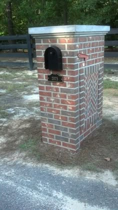 a brick mailbox sitting on the side of a road