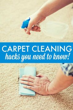 a person is cleaning the carpet with a blue cloth and a spray bottle in their hand