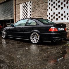 a black car parked in front of a building