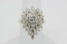 Platinum Pear Shaped Diamond Cluster Ring, .33 center stone approximately 1ct. total weight, G SI 1, Ring size 4.75, 7/8 inch across, Circa 1950, weight 6.21 grams Stock # BB108R10 Most rings are sizable for a small fee. If the ring you are considering is the incorrect size contact us for a quote. This listing contains photographs of the actual item you will receive. Our items are in excellent condition with little or no signs of wear and many are one of a kind pre-owned estate finds. Please loo Vintage White Marquise Ring, Vintage White Marquise Cut Rings, Pear-shaped Diamond Cut Cluster Ring For Anniversary, Pear-shaped Brilliant Cut Cluster Ring For Anniversary, Pear-shaped White Gold Cluster Ring For Anniversary, Vintage White Gold Pear-shaped Rings, Vintage White Cluster Ring With Brilliant Cut, Vintage Pear-shaped Diamond White Jewelry, Vintage White Cluster Diamond Ring