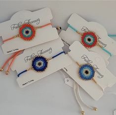 four bracelets with evil eye designs on them