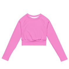 This super sweet pink long-sleeve crop top from Extremely Stoked is made of a smooth, good feeling, recycled polyester and elastane, making it an eco-friendly choice for swimming, sports, or athleisure outfits. The crop top has a tear-away care label and a wide, double-layered waistline band for a super comfy fit.• UPF 50+• Trendy, cropped fit• Wide, double-layered waistline band• Raglan sleeves• Tear-away care label• Size up if you’re between sizes as this fabric can be tight on the bodyThis pr Pink Long Sleeve Crop Top, Athletic Shorts Women, Compression Wear, Athletic Swimwear, Plus Size Workout, Flared Leggings, Pink Crop Top, Cropped Tops, Athleisure Outfits