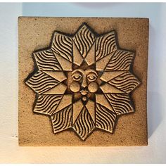 a decorative tile with a sunflower design on the outside and an eye in the center