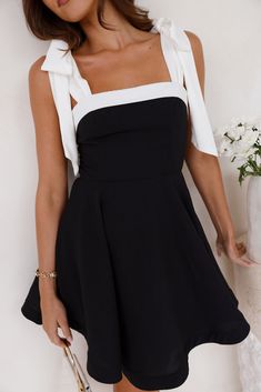 Length from shoulder to hem of size S: 80cm. Chest: 38cm, Waist: 33cm, size S. Mini dress. Lined. Model is a standard XS and is wearing XS. True to size. Non-stretch. Tie-up white shoulder straps. Flowy skirt. Zipper with hook eye closure. Dry clean only. Polyester. Own the room when you step in with the Sunday Nights Mini Dress. Featuring tie-up white shoulder straps and a gorgeous flowy skirt. Style with heels for likes! First Day Outfit, Skirt Zipper, Shower Dresses, Jumpsuits And Romper, Mini Dress Black, Graduation Outfit, Long Sleeve Lace Dress, Dresses Backless, Flowy Skirt