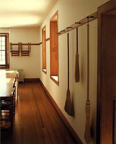 an empty dining room with wood floors and hanging utensils