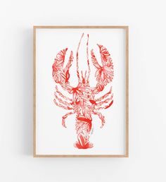 a red lobster print hanging on a wall next to a wooden framed frame in front of a white wall