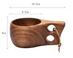 a wooden bowl with holes in the middle and a rope on the bottom that is attached to it