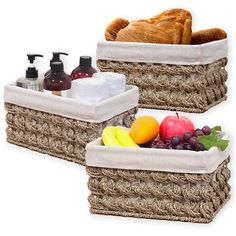 two baskets filled with fruit and bread next to each other