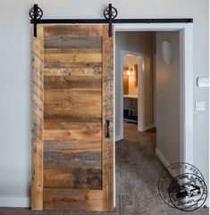 an open wooden door in a room with carpeted flooring and white walls on either side