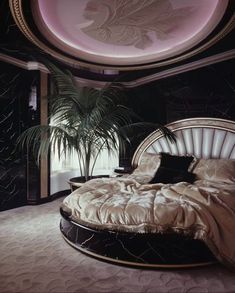 a large bed sitting in the middle of a room next to a plant on top of a table