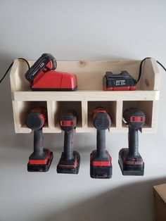 a shelf with drillers and tools hanging from it