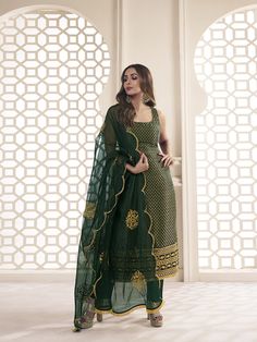 This great winter ensemble from Malaika Arora is perfect for your next special occasion. It includes a bottle green kurta set crafted from silk blend brocade, cotton and organza. Featuring Zari woven designs, a U-neck and calf length trousers, this set is sure to make a statement. It is dry clean only and designed specifically by the Bollywood Diva herself. TOP: Silk Blend(Brocade), TOP INNER: Cotton, BOTTOM: Cotton, DUPATTA: Organza, Dry Clean