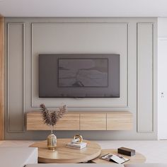 a living room with a large tv mounted on the wall above a wooden coffee table