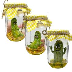 three glass jars with faces and hands in them, one has a yellow gingham cloth on the top