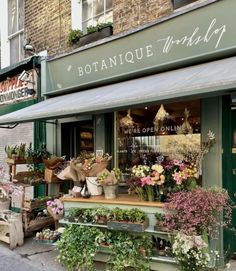 a flower shop with lots of flowers outside