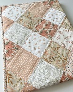 a close up of a patchwork quilt on a table