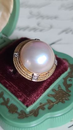 Gorgeous mid century Mabe Pearl and Diamond cocktail style ring crafted in 14k yellow gold. The natural Mabe Pearl displays an array of soft pastel colors. The luster and sheen are spectacular. Accenting the Mabe Pearl are four diamonds, each individually set in 14K white gold. They are placed along the yellow gold rope design rim.  Ring Measures 23mm in diameter  Mabe Pearl measures approximately 17mm Size 8 Hallmarks 14K 585 8.9 gms ttw Three Diamond Ring, Champagne Diamond Rings, Soft Pastel Colors, Diamond Cocktail Ring, Mabe Pearl, Diamond Cocktail Rings, Rope Design, Ring Crafts, Champagne Diamond