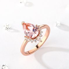 This captivating engagement ring features an enchanting pear-shaped morganite that radiates blushing hues at the center. Sparkling round stones dance down the band, which is fashioned in romantic rose gold tone sterling silver.Carat Weight: 1.815 ctStone Size: 7*10 mmNumber of Stones: 1 Stone Shape: PearStone Color: Fancy PinkCarat Weight: 0.7 ctStone Size: 2*3,1.5 mmStone Type: Jeulia® StoneNumber of Stones: 9 Stone Shape: Pear, RoundStone Color: Diamond WhiteWeight: 3.1 gWidth: 2.66 mmHeight: 5.9 mmThickness: 1.2 mmMaterial: 925 SilverPlating Color: Rose Gold Pear Cut, Romantic Roses, Morganite, Pear Shaped, Pear, Sterling Silver Rings, Gold Tones, Sparkle, Silver Rings