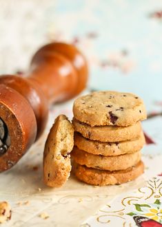 a stack of cookies next to a rolling pin