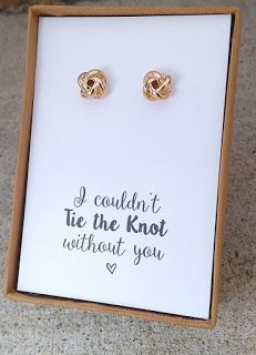 a pair of earrings in a box with the words i couldn't tie the knot without you