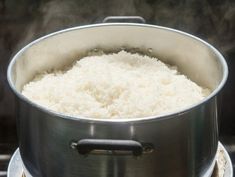 a large pot filled with white rice on top of an open burner stovetop