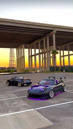 three cars parked in a parking lot next to each other with the sun setting behind them