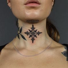 a woman's neck with a cross tattoo on the top and bottom part of her neck