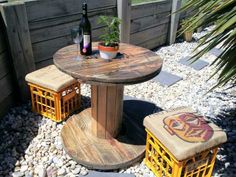 two yellow crates sitting on top of a gravel covered ground next to a wooden table