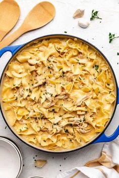 a blue pot filled with pasta and chicken