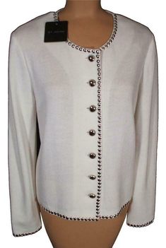 New Women's St. John Collection. All original tags attached. Retail price $1495.00 Size 12. Made from 78% Wool and 22% Rayon.   Bright White is the color as per tag. Bright White Santana Knit Long Sleeve Button Up Jacket with Silver St. John embossed Buttons and Sequin Detail. Sewn in shoulder pads.  Shoulder measurement is 17" Sleeve length is 25" Bust measurement is 42" and Jacket length down the center of back 22". Measurements will stretch. New, never worn. Designer Cream Sweater For Fall, Designer White Cardigan For Fall, Luxury White Cardigan For Fall, Designer Formal Cardigan With Button Closure, Designer Button Sweater For Fall, Designer Long Sleeve Sweater With Buttons, Designer Winter Formal Cardigan, Designer Winter Sweater For Formal Occasions, Designer Fall Sweater With Buttons