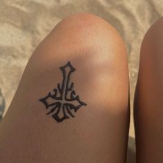 a close up of a person's legs with a tattoo on their left leg