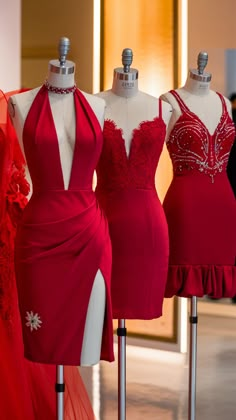 three dresses on mannequins in front of a mirror