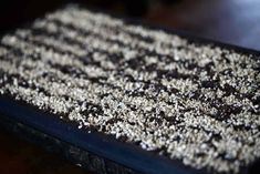 a close up view of some kind of food on a table with brown and white crumbs