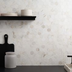 a kitchen counter with two black and white dishes on top of it, next to a cutting board