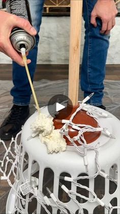 a man is decorating a cake with white icing and brown caramel sauce