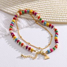 Tropical Layered Beads Bracelet/Anklet with Initials in Gold Plating - 1 product photo Trendy Multicolor Anklets With Round Beads, Trendy Multicolor Round Bead Anklets, Trendy Multicolor Beaded Anklets, Summer Gold Beaded Bracelets With Letter Beads, Summer Gold Beaded Bracelets, Summer Gold Bracelets With Letter Beads, Trendy Beaded Chain Bracelets For Summer, Trendy Summer Beaded Chain Bracelet, Summer Gold Bracelet With Letter Beads