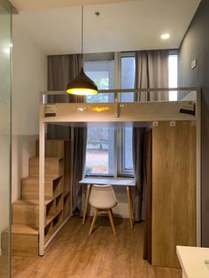 there is a loft bed in the middle of this room with stairs to the second floor